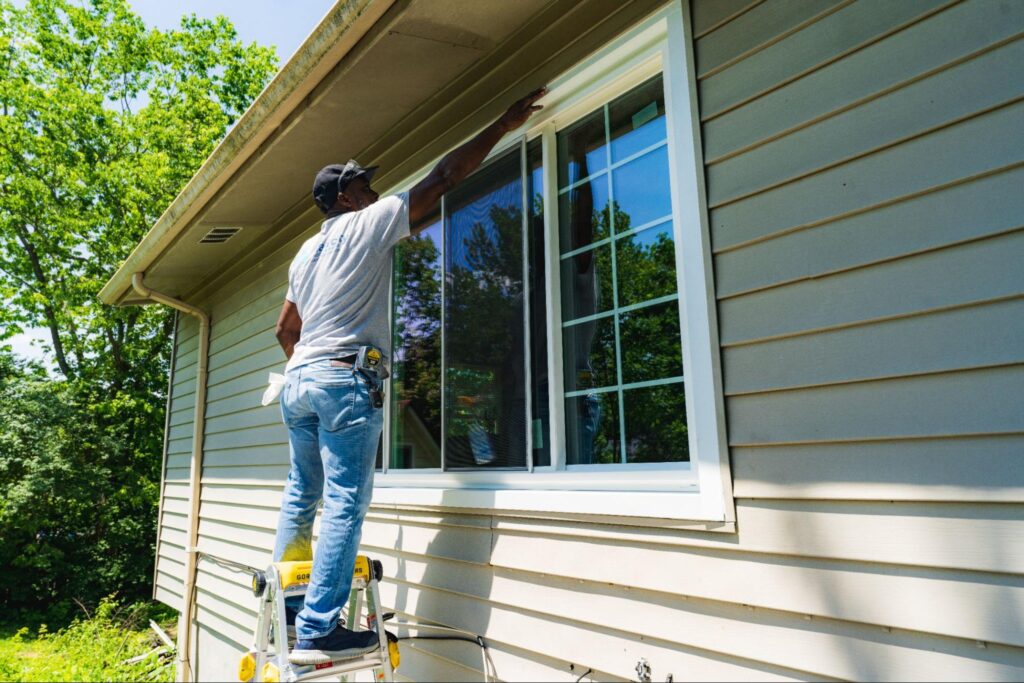FHIA contractor installing a window