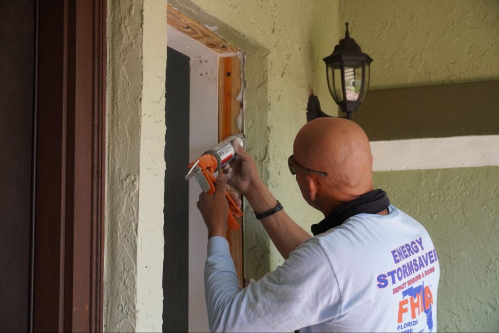 FHIA contractor caulking a door frame