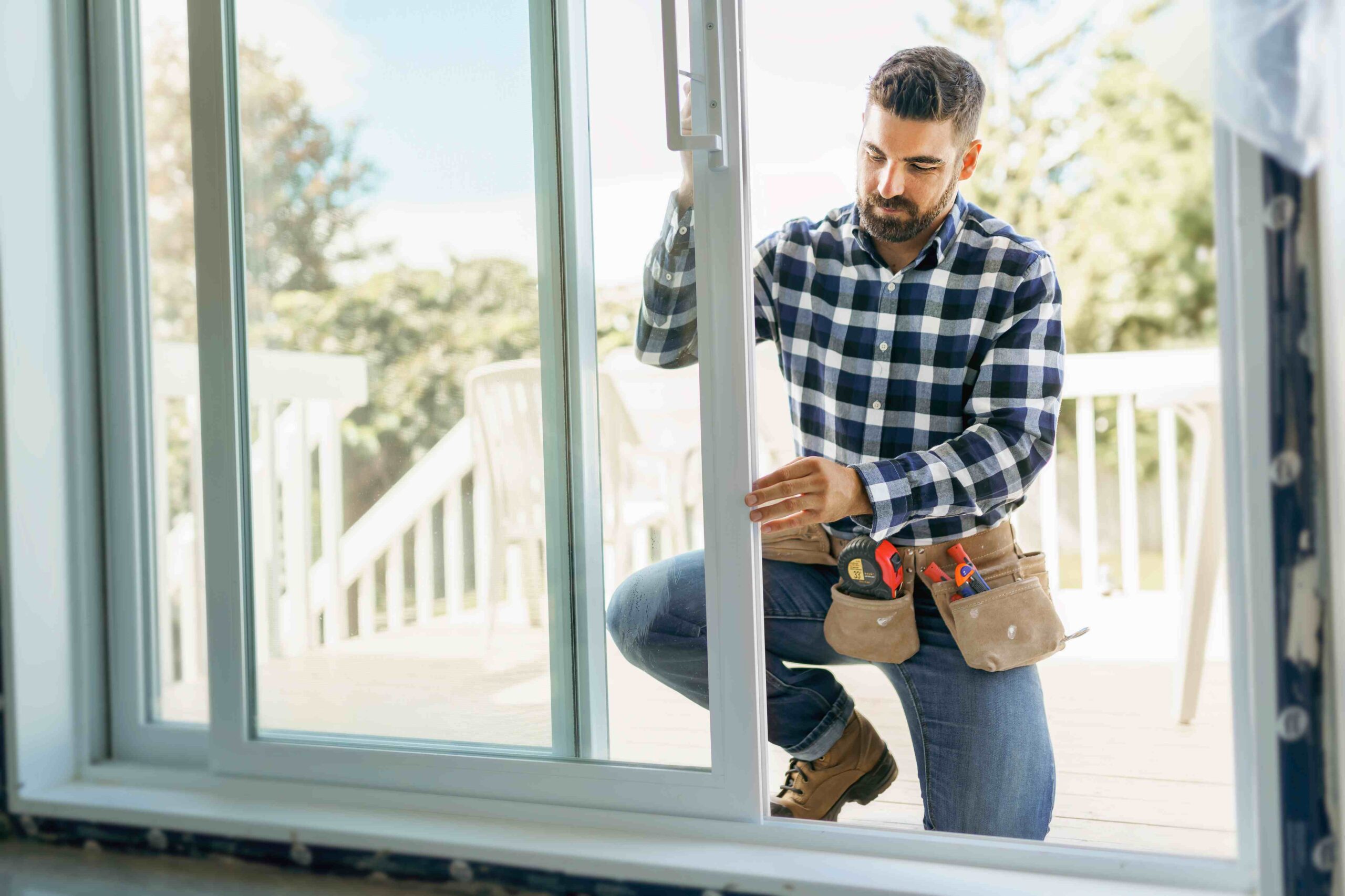 man installing sliding glass door