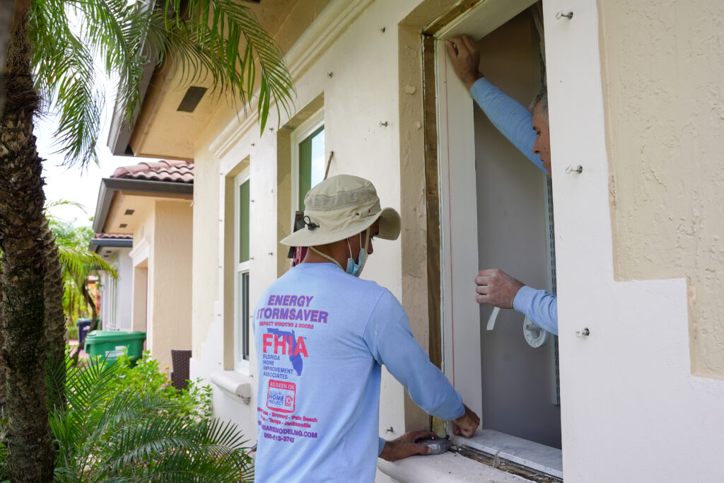 FHIA installers installing a new impact window